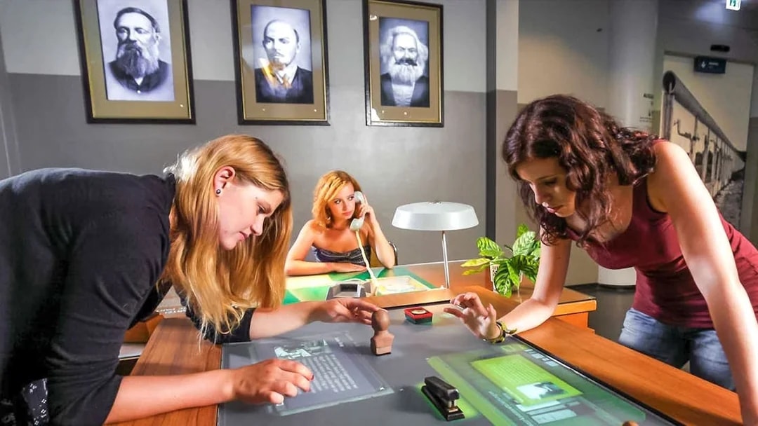 Visitors interacting with exhibits at DDR Museum Berlin.
