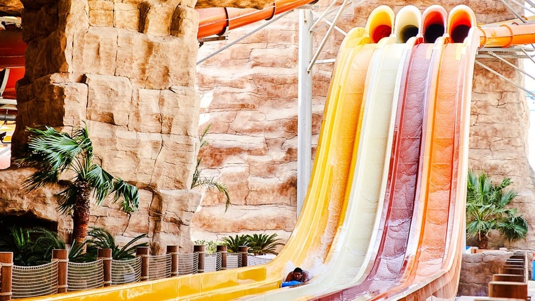 Water slide with colorful lanes in Doha theme park.
