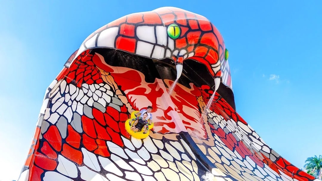 Riders on King Cobra water slide in Doha.