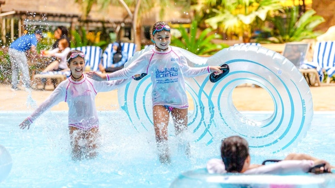Children enjoying water activities at a Doha water park.