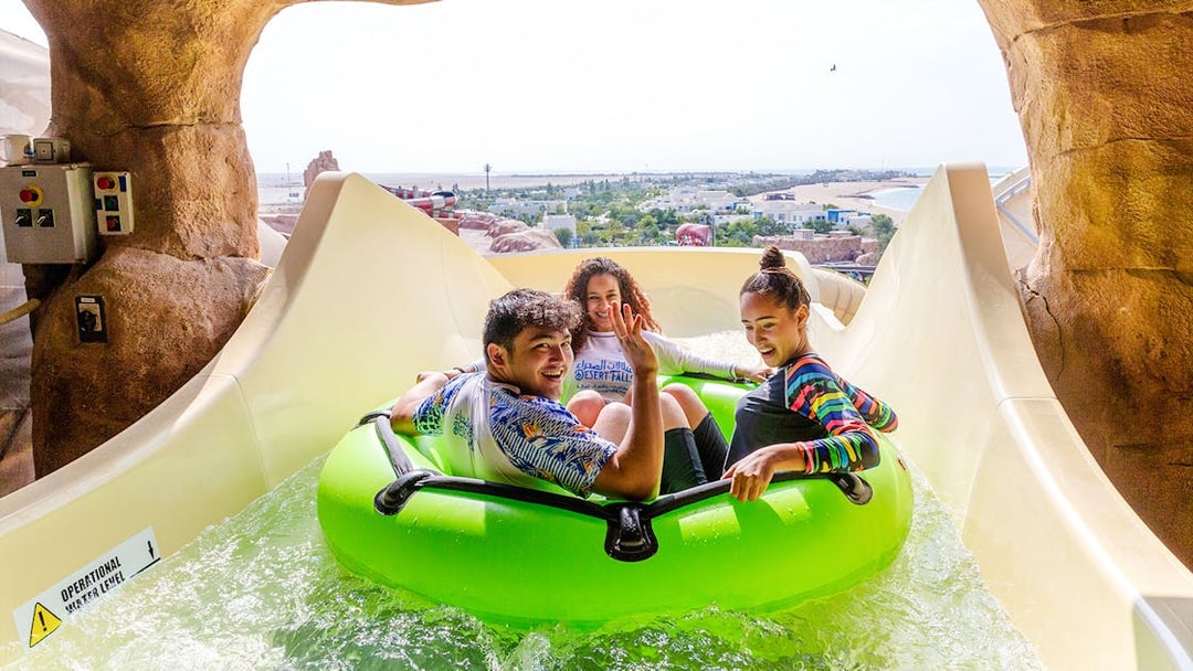 Group enjoying water slide ride in Doha.