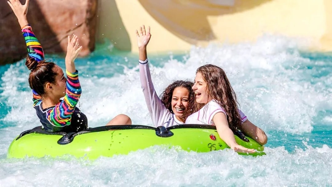 Kids enjoying a water ride at a water park in Doha.