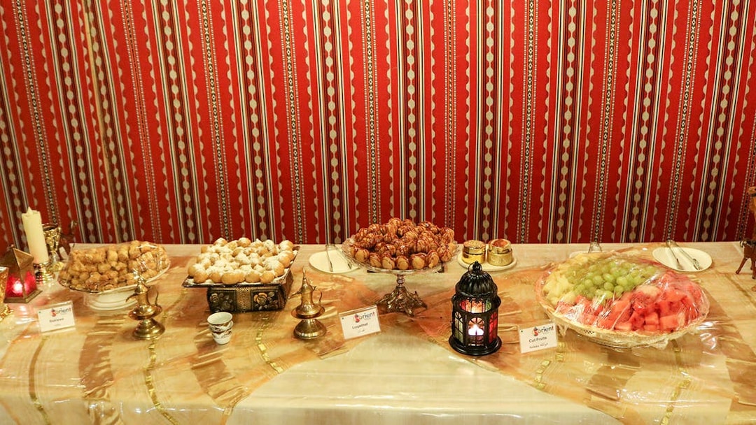 Traditional Middle Eastern dessert spread with lantern, part of Desert Wonder evening safari experience.