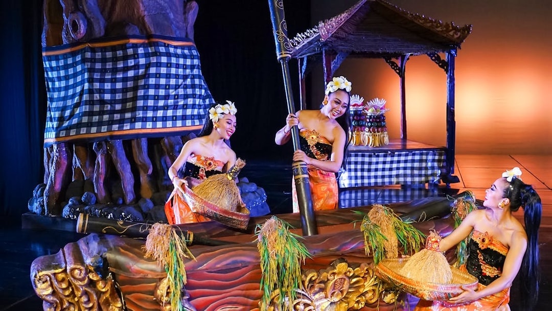 Performers on stage during the Devdan Show in Bali, showcasing traditional costumes and cultural elements.