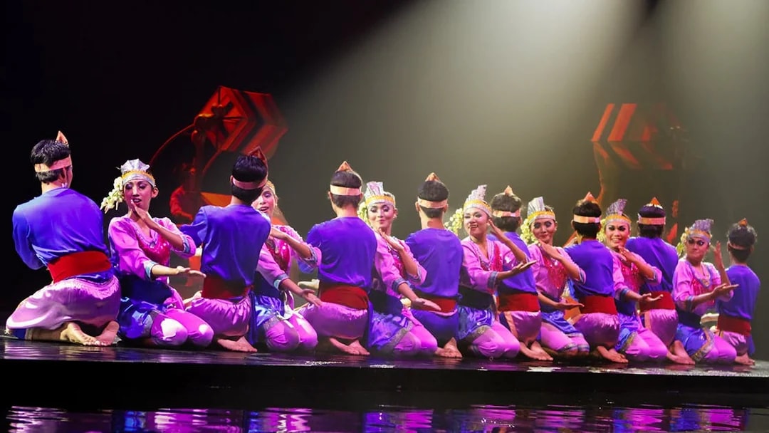 Performers in traditional attire on stage during the Devdan Show in Bali.