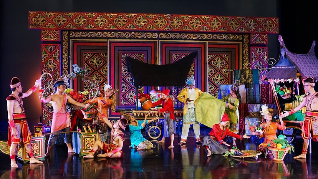 Performers in traditional costumes on stage during the Devdan Show in Bali, showcasing cultural dance.
