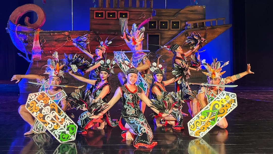 Performers in traditional costumes on stage during the Devdan Show in Bali.
