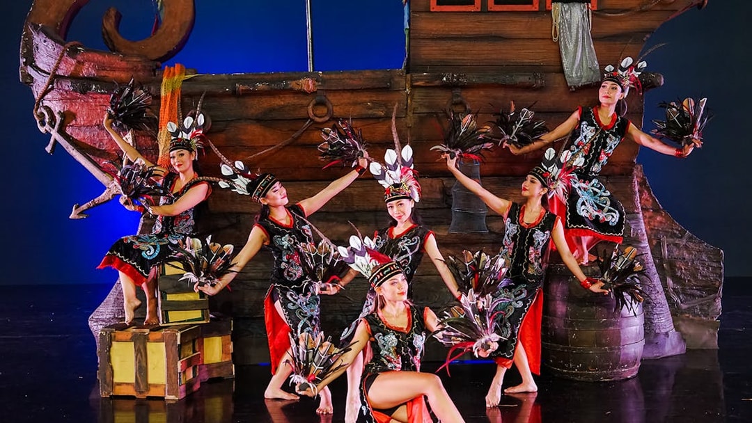 Performers on stage during the Devdan Show in Bali, showcasing traditional dance.