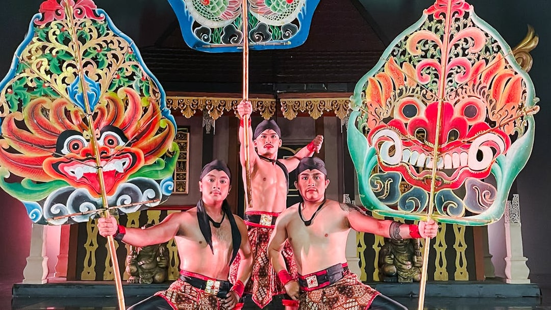 Performers holding ornate shields during the Devdan Show in Bali, showcasing cultural artistry.
