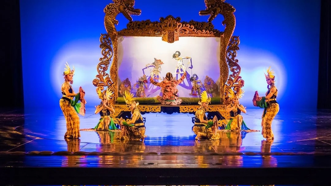 Performers on stage during the Devdan Show in Bali, showcasing traditional dance and puppetry.