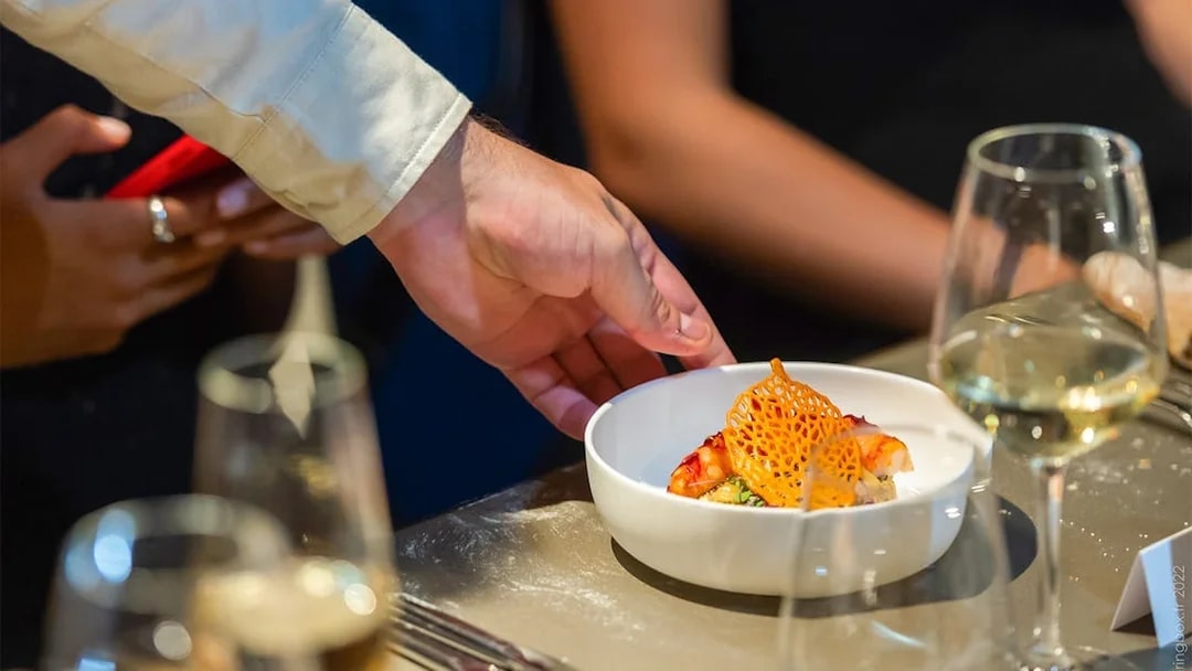 Waiter serving a gourmet dish at Madame Brasserie, Paris.
