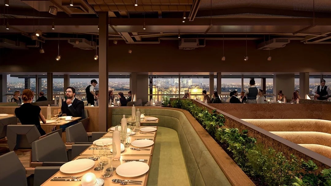 Dining area inside Eiffel Tower's Madame Brasserie with city view.