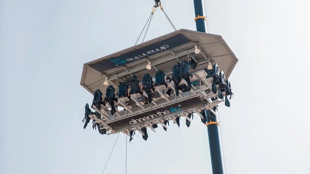 Guests dining on a suspended platform for Dinner in the Sky experience.