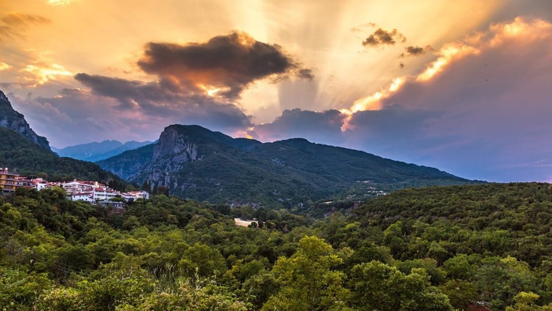 Sunset over Mount Olympus with lush green landscape, viewed from Dion, Greece.