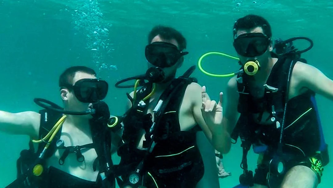 Group scuba diving in Dubai waters.