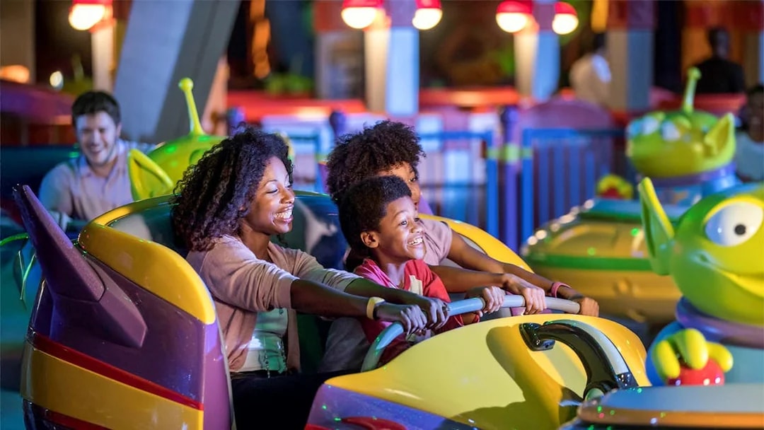 Family enjoying bumper cars at Toy Story attraction, Walt Disney World Resort, Orlando.
