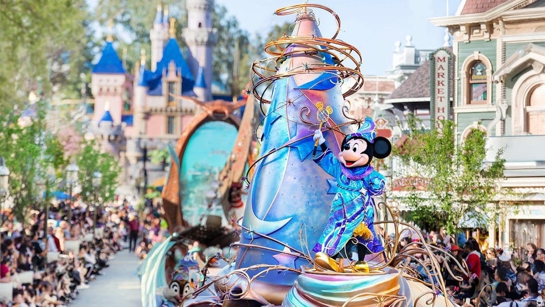 Mickey Mouse in a vibrant costume on a parade float at Disneyland Park, California.