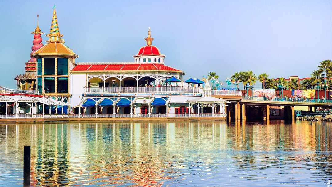 Colorful waterfront building at Disneyland Park, California, reflecting in the water.