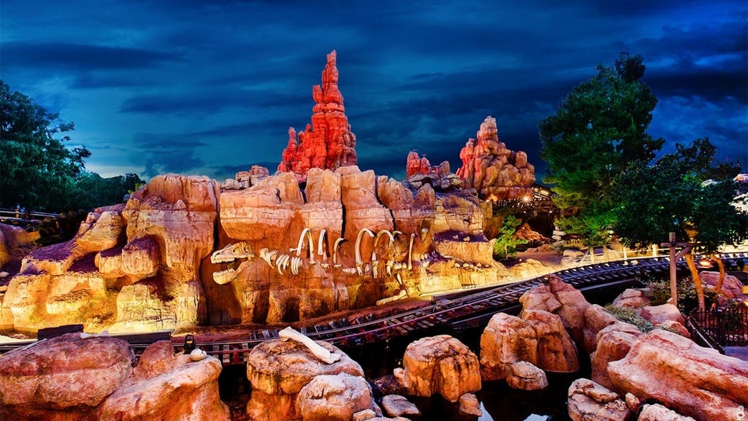 Frontierland's Big Thunder Mountain Railroad at Disneyland Park, California, with rocky landscape.