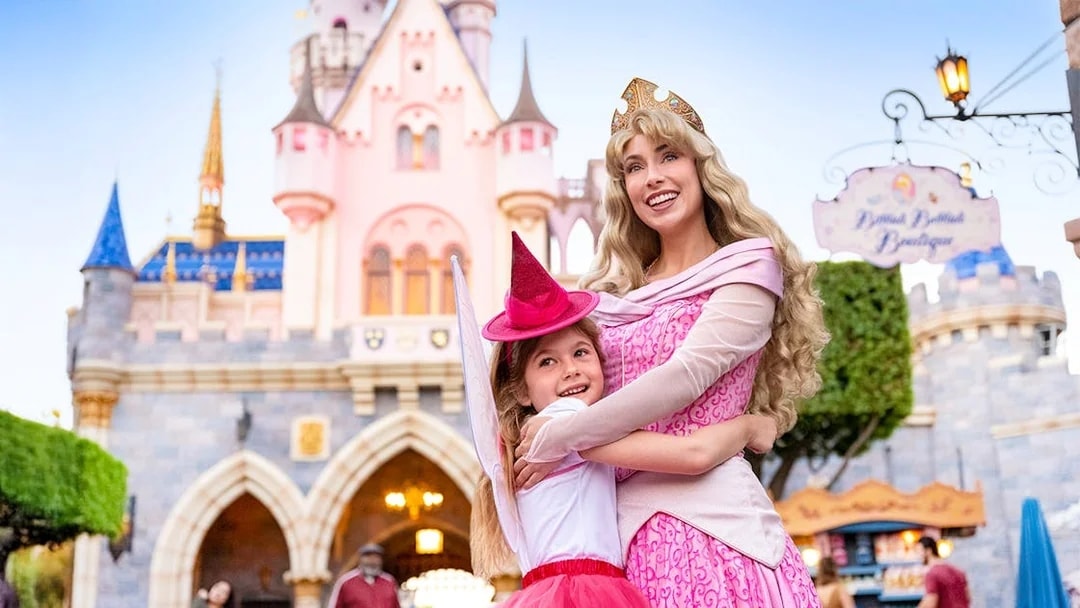 Child meeting a princess in front of Sleeping Beauty Castle, Disneyland Park, California.