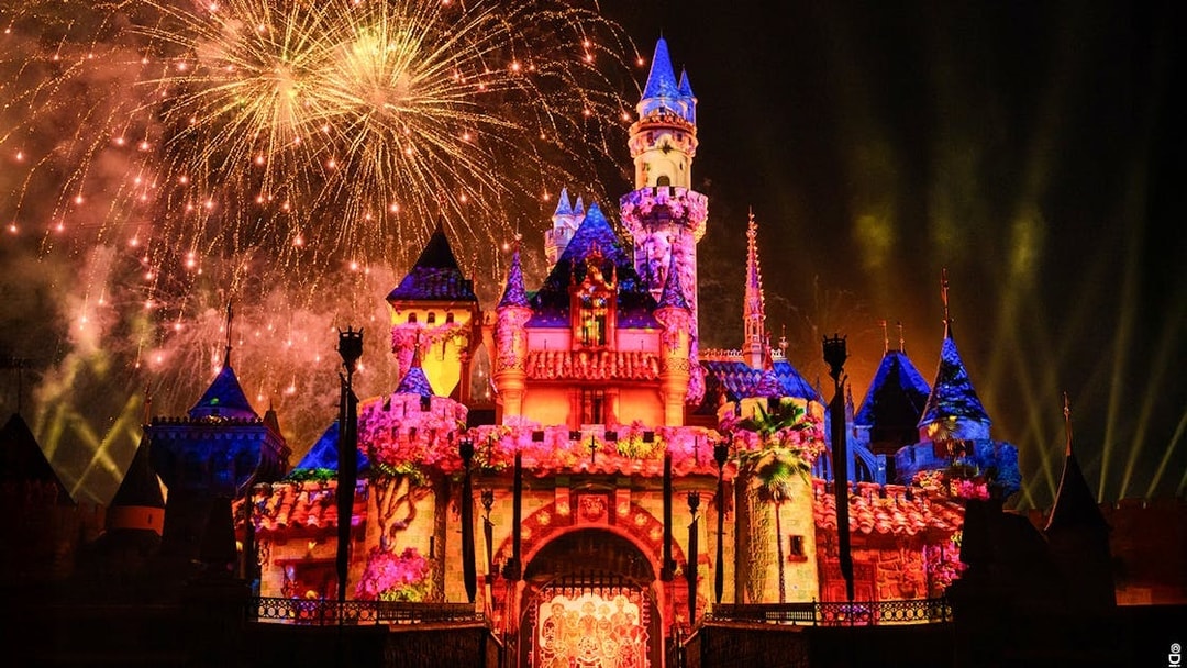 Fireworks illuminate Disneyland Castle at night in Disneyland Park, California.