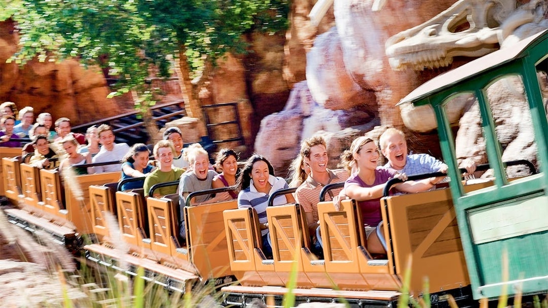 Visitors enjoying a roller coaster ride at Frontierland, Disneyland Park, California.