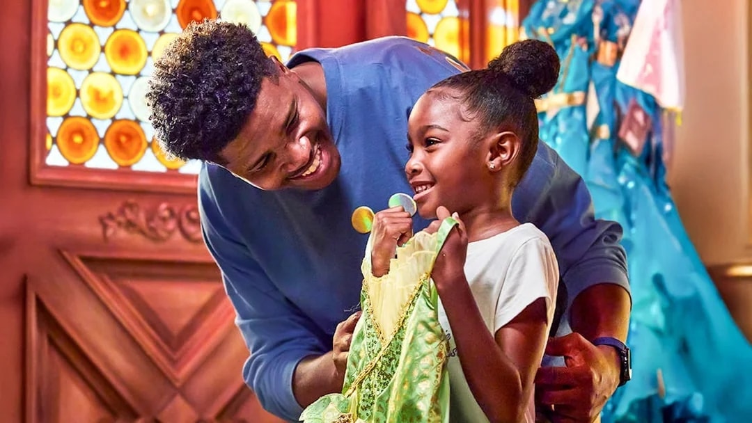 Child holding a princess dress at Disneyland Park, California.