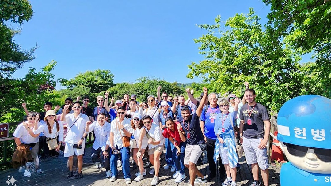 Tour group on wooden path surrounded by trees during DMZ tour from Seoul.