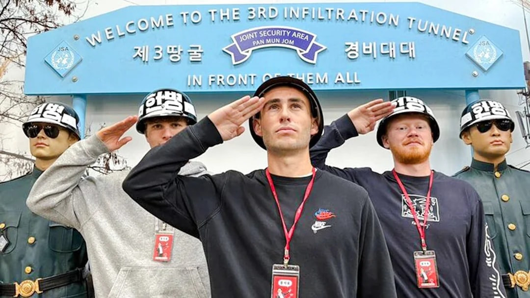 Tourists saluting with soldier mannequins at the 3rd Infiltration Tunnel entrance, DMZ, South Korea.