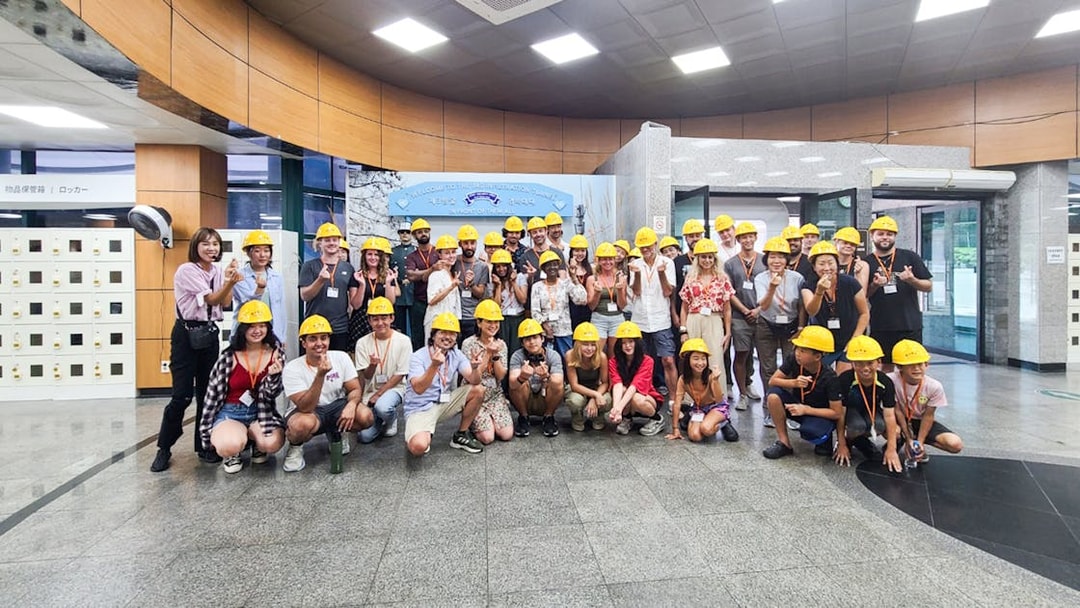 Tour group wearing helmets at the entrance of the Third Infiltration Tunnel, DMZ, South Korea.