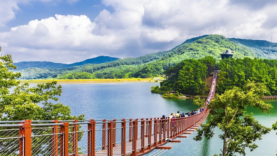 Lake Majang Suspension Bridge at Korean DMZ with visitors crossing over water.