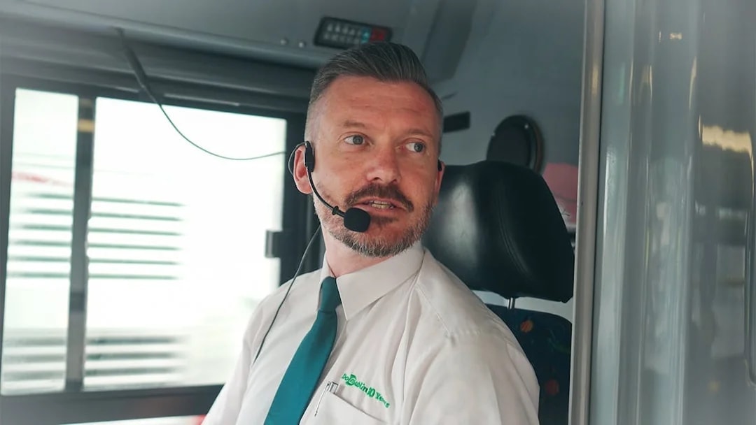 Live guide speaking on hop on hop off bus in Dublin.