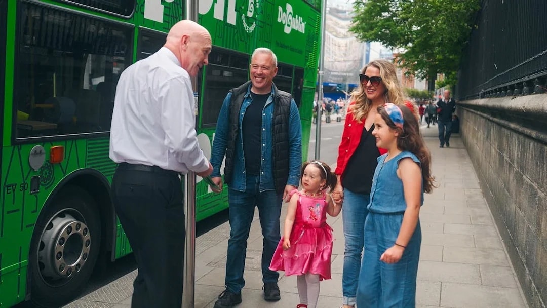 Family boarding Dublin hop-on hop-off bus with guide.