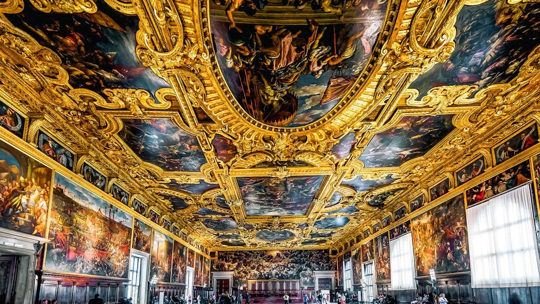 Great Council Hall, Venice, with ornate gilded ceiling and historic paintings.