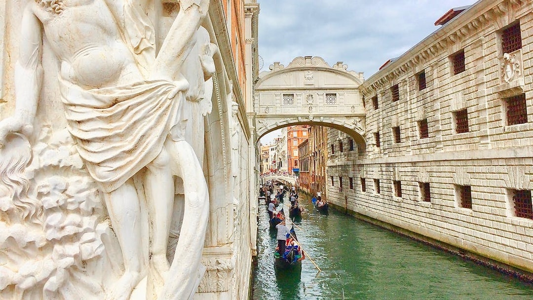 Gondola ride near Bridge of Sighs on a canal in Venice, Italy.