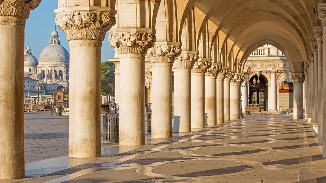 Doge's Palace arches with tourists using Venice Museum Pass for fast-track entry.