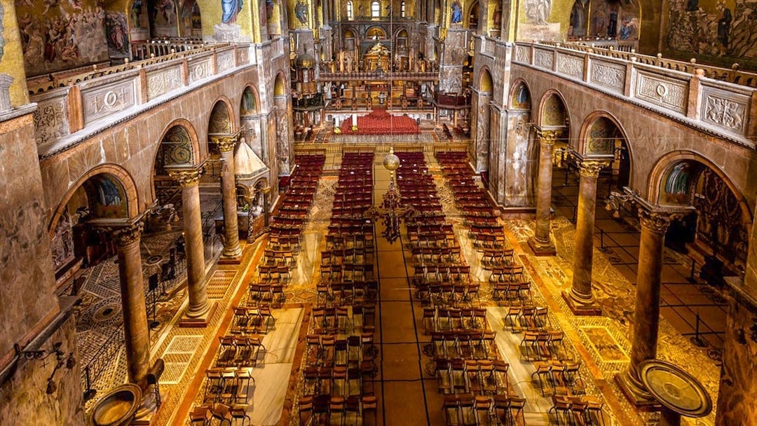 Interior of St. Mark's Basilica in Venice, showcasing ornate columns and detailed mosaics.