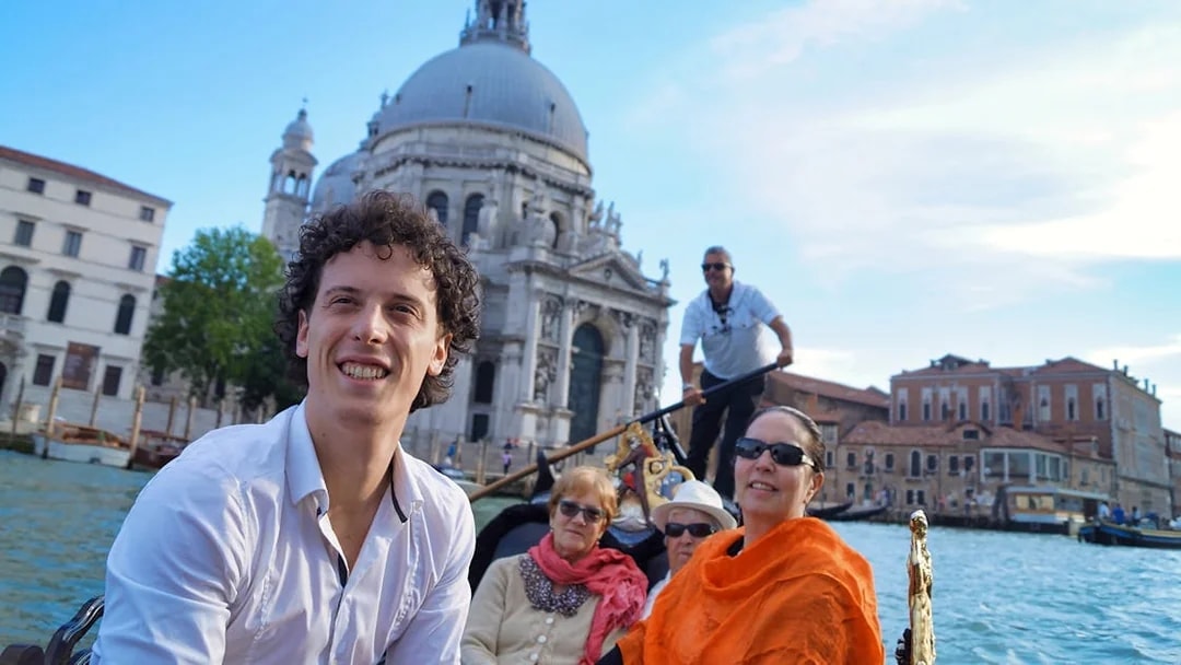 Gondola ride near Doge's Palace, Venice, with tourists enjoying the view.