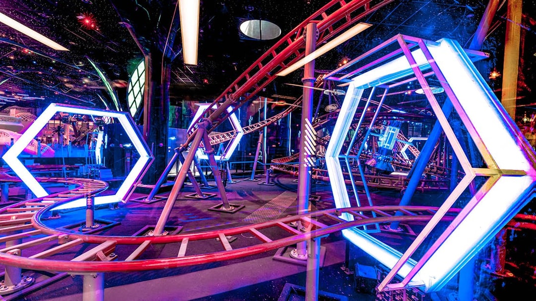 Roller coaster track with neon lights at Doha Quest Theme Park.