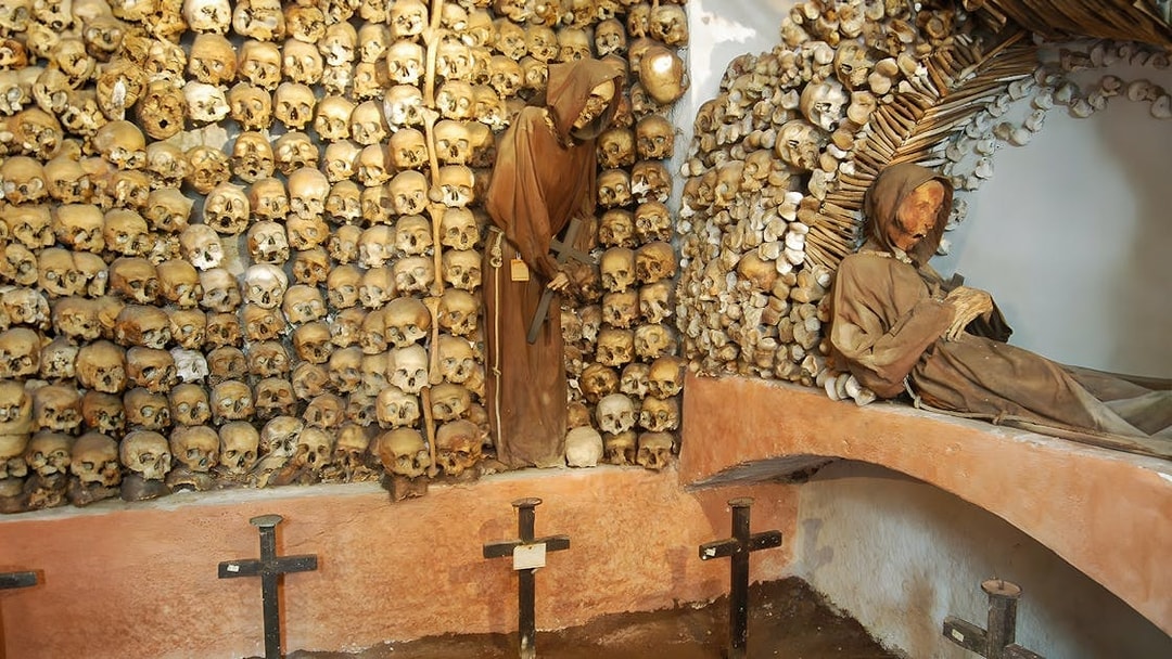 Skulls and monk figures in the Capuchin Crypt, Rome catacombs.