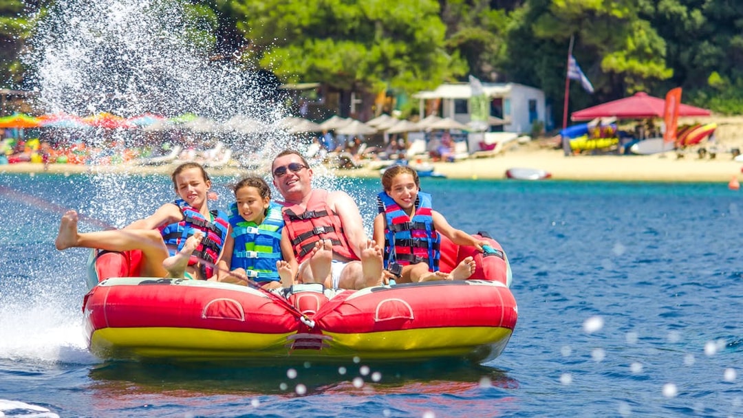 Family on a donut tube water ride in Dubai.