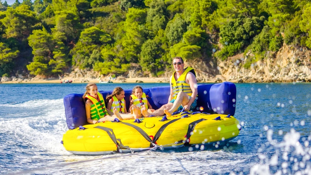Family on a donut tube water ride in Dubai.