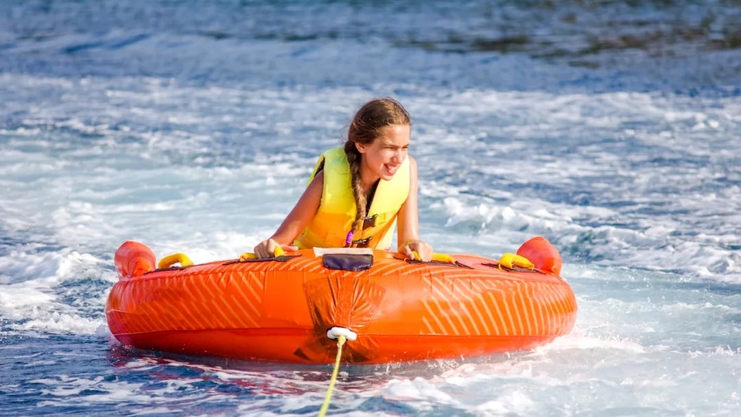 Girl enjoying donut ride water sport in Dubai.