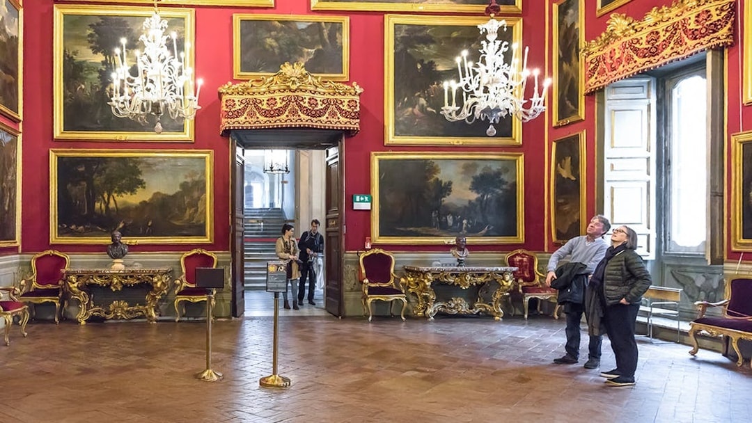 Visitors admiring artwork in the ornate Doria Pamphilj Gallery, Rome.