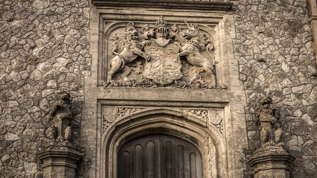 Dover Castle stone doorway with intricate coat of arms and lion sculptures.