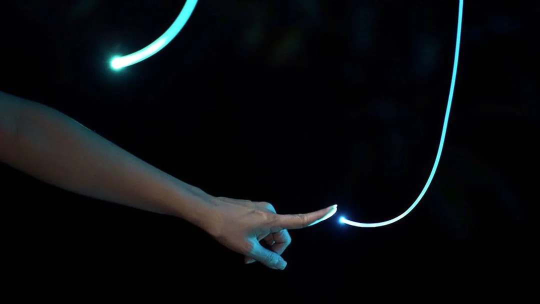 Hand touching glowing light trail in Dream Forest Langkawi.