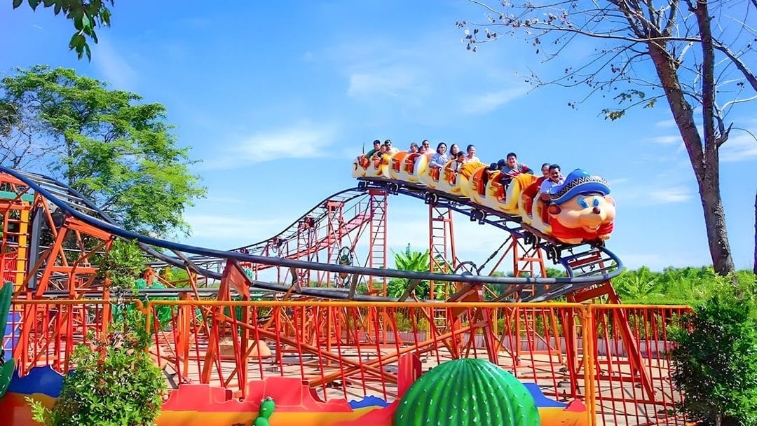 Roller coaster with passengers at Dream World Bangkok.