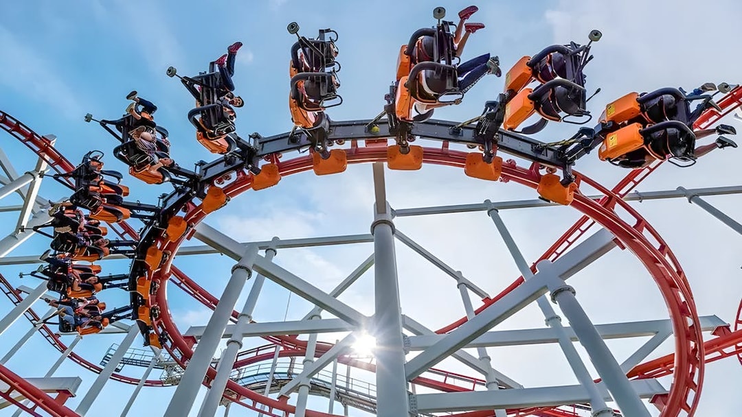 Roller coaster loop at Dream World Bangkok with riders upside down.