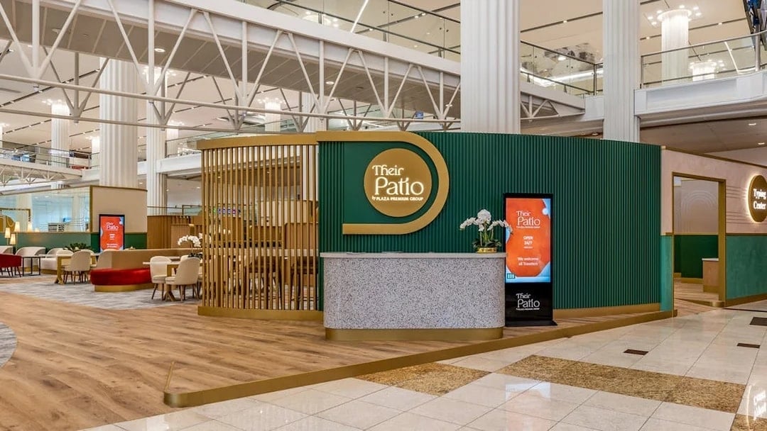 Premium lounge entrance at Dubai International Airport with seating area and reception desk.