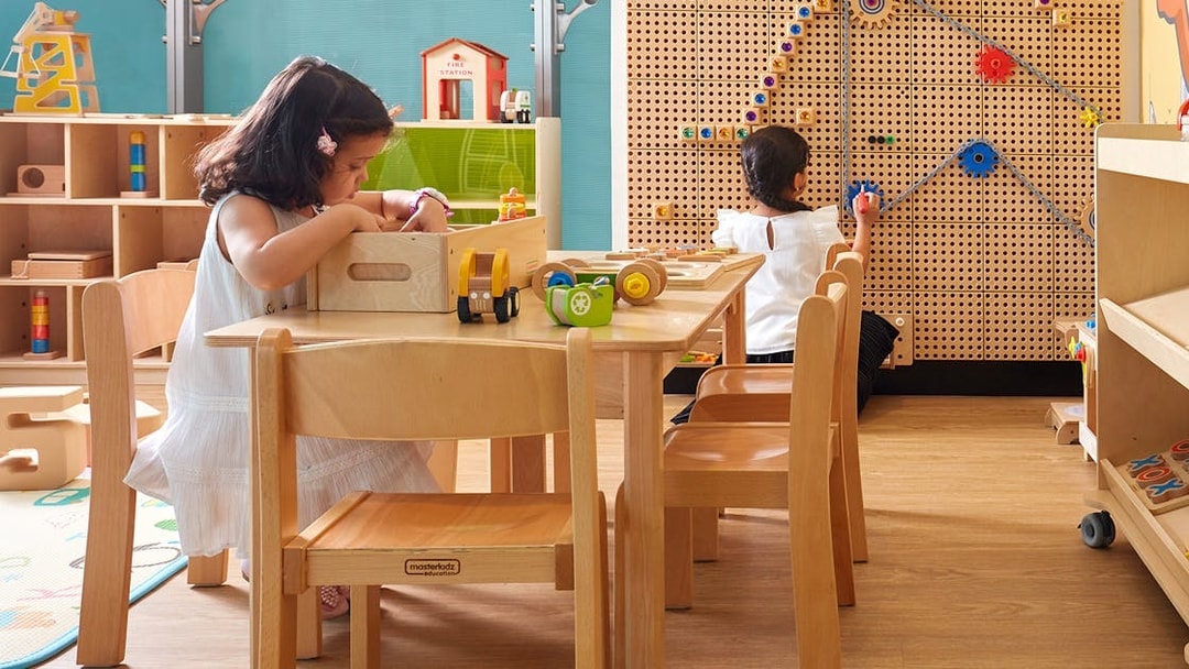 Children playing in a kids' area at Dubai International Airport premium lounge.